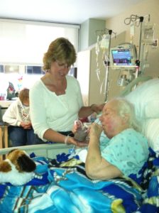 Mom blowing bubbles in her chocolate Ensure. 